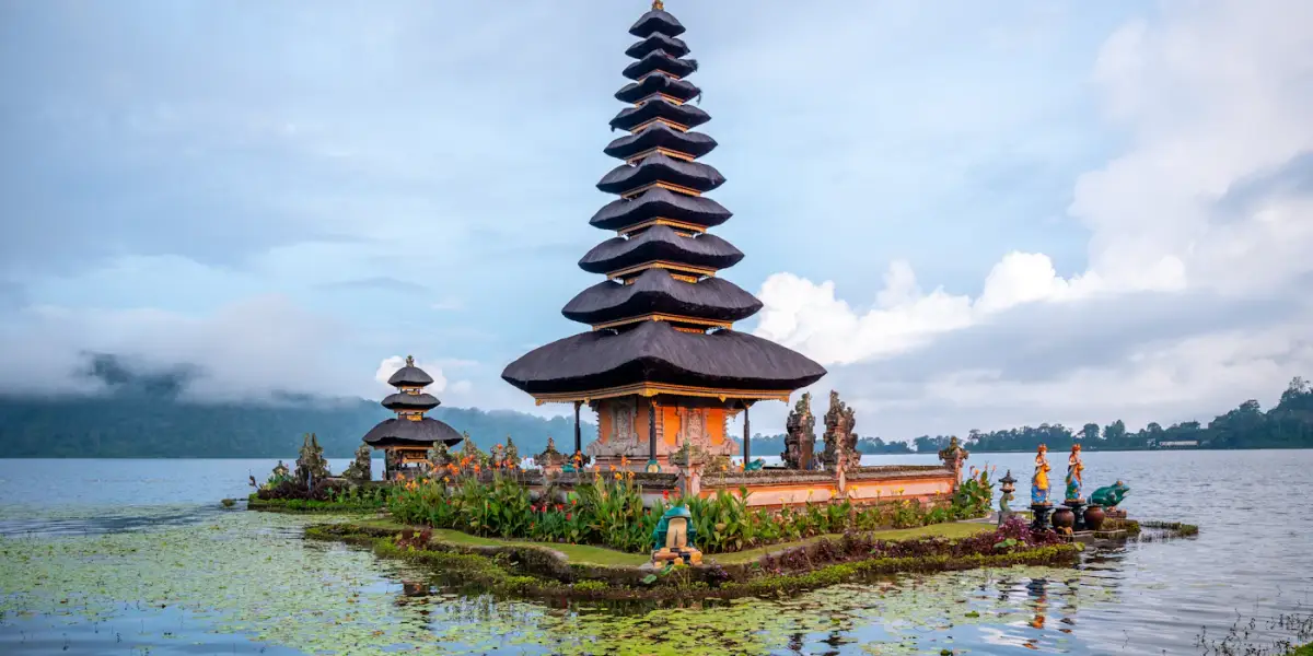 The eleven-tiered shrine of Pura Ulun Danu Beratan on Lake Beratan in the Bedugul highlands, with cloud over the hills behind