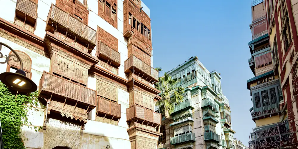 Old houses with carved wooden roshan balconies along a street in Jeddah's historic Al-Balad